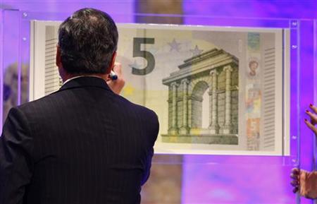 Draghi, President of the European Central Bank (ECB) , signs an oversized new unveiled 5 euro note Frankfurt